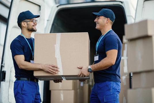 Professional movers loading boxes into a moving truck outside a Los Angeles home