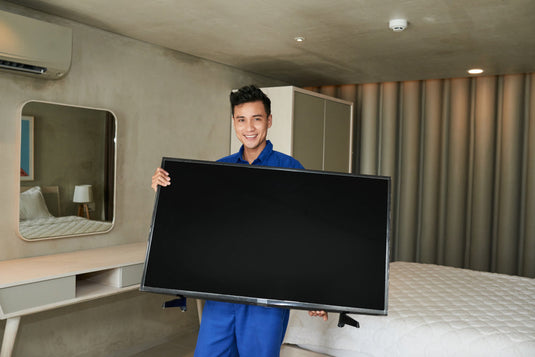Wrapping a flat-screen TV in bubble wrap before packing it for a Los Angeles move