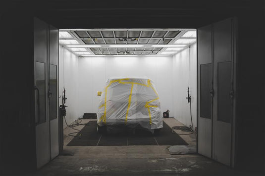 Car covered with a protective sheet while stored in a storage unit