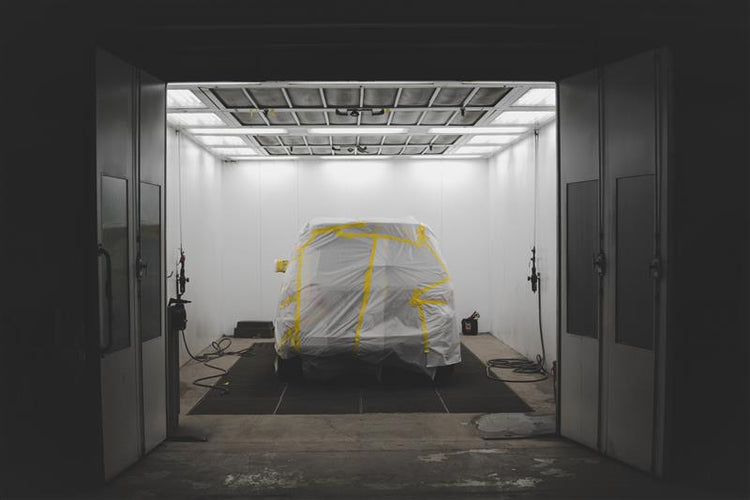 Car covered with a protective sheet while stored in a storage unit